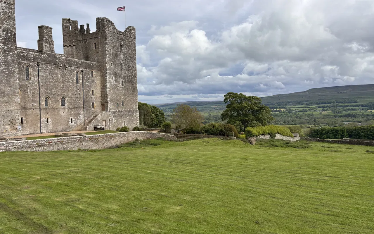 Dales, Castles & Villages private day tour — a historic Yorkshire Dales castle amid rolling stone-walled countryside
